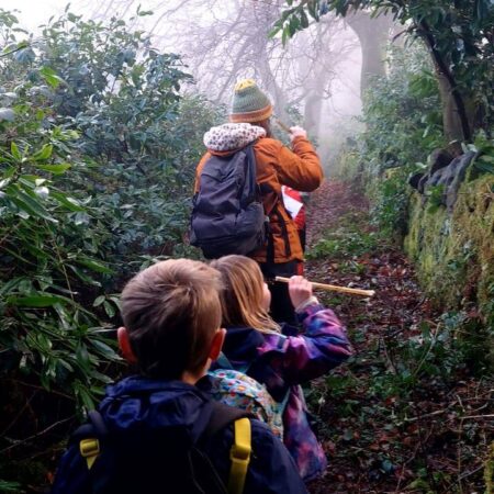 People Walking Down A Grassy Path