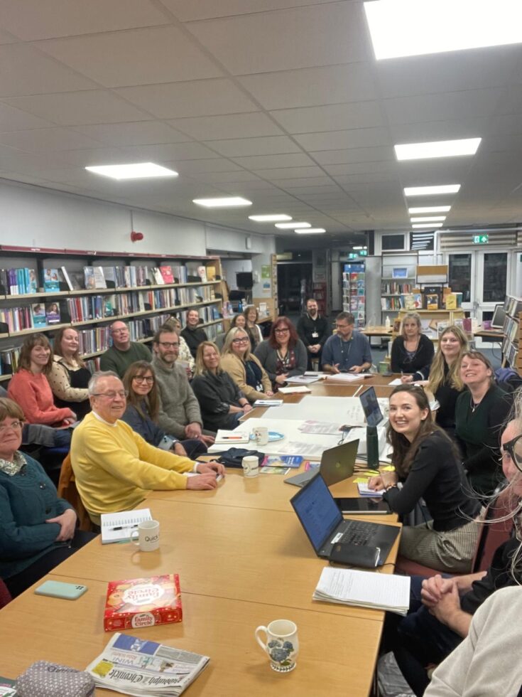 A Group Of People Around A Table