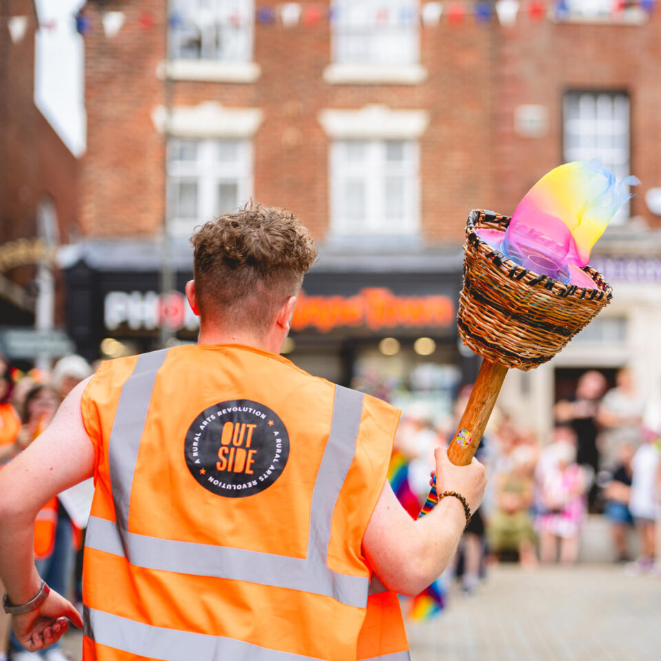 Pride in the moorlands torch being carried to the pride parade